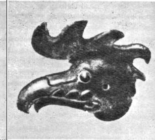 Голова птицы, вырезанная из дерева